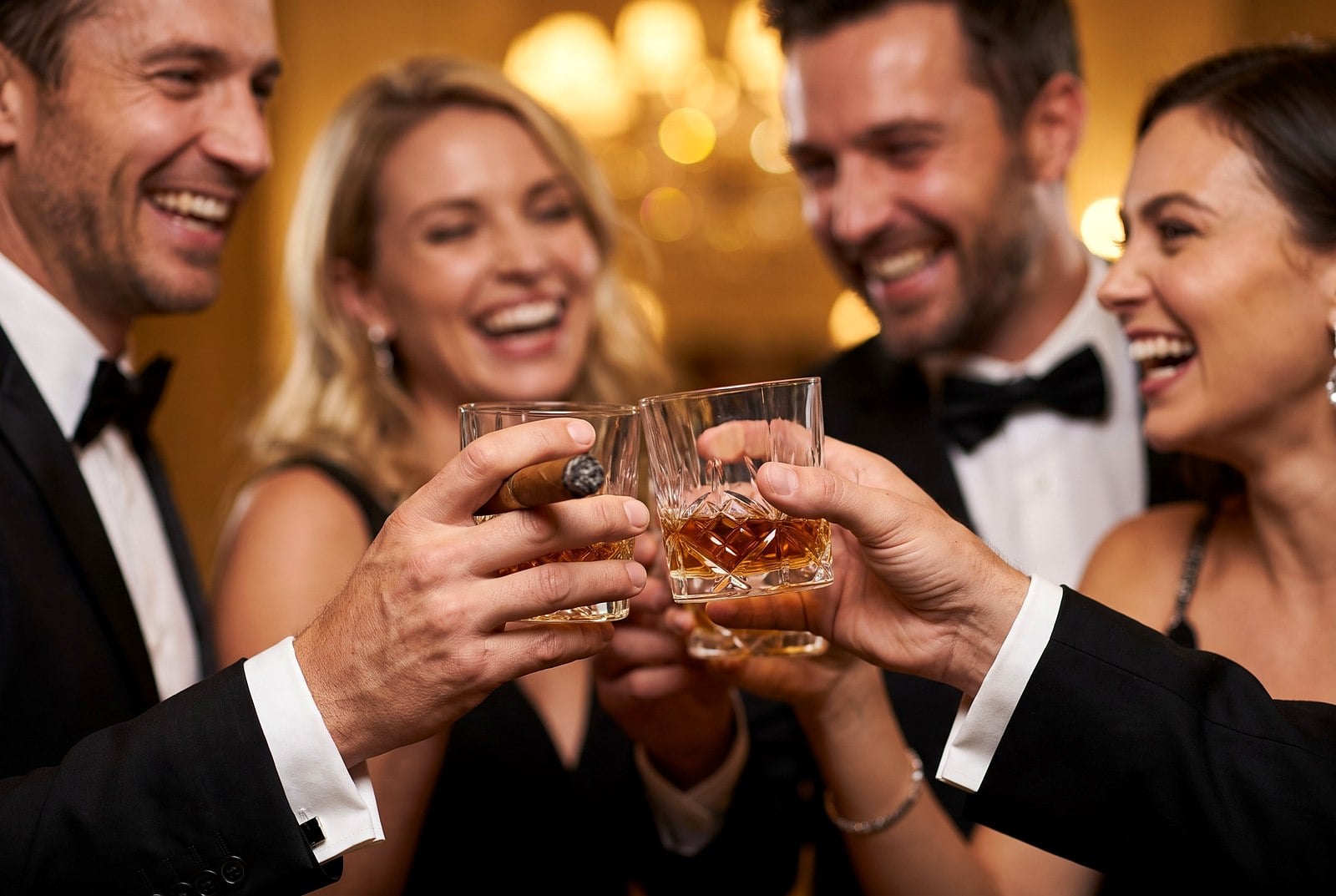 A celebratory toast with cocktails and a cigar